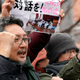 Protesters shout slogans outside the venue of an evacuation drill simulating a North Korea ballistic missile attack in Tokyo.